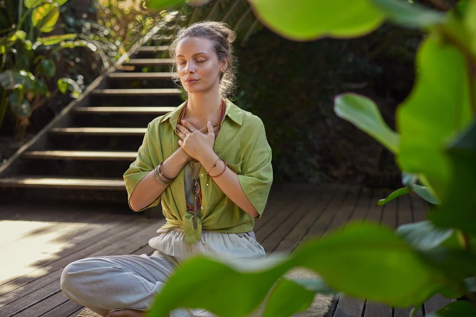 Young beautiful woman meditating in retreat
